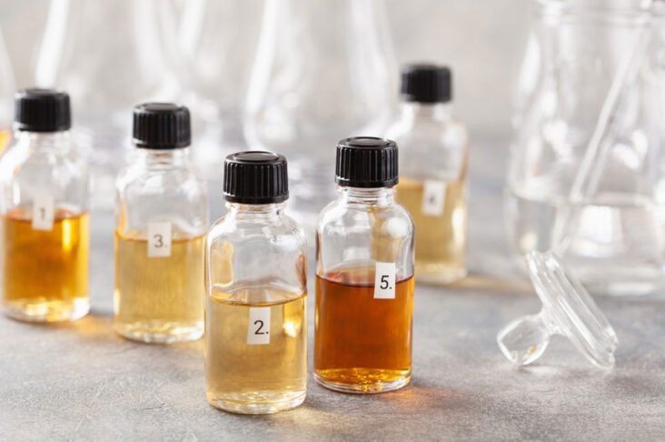 Labeled sample vials with different liquid colors used in beverage testing and quality control in a beverage laboratory