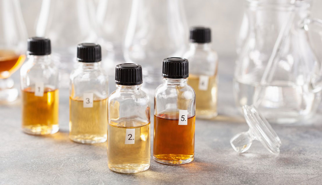Labeled sample vials with different liquid colors used in beverage testing and quality control in a beverage laboratory