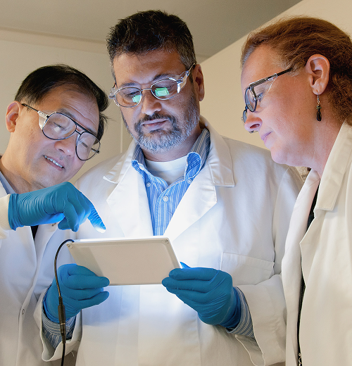 Scientests Viewing a Tablet Scientests Viewing a Tablet