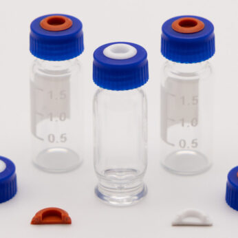 Blue screw caps with red and white septa displayed with glass sample vials and molded liner inserts