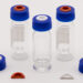Blue screw caps with red and white septa displayed with glass sample vials and molded liner inserts