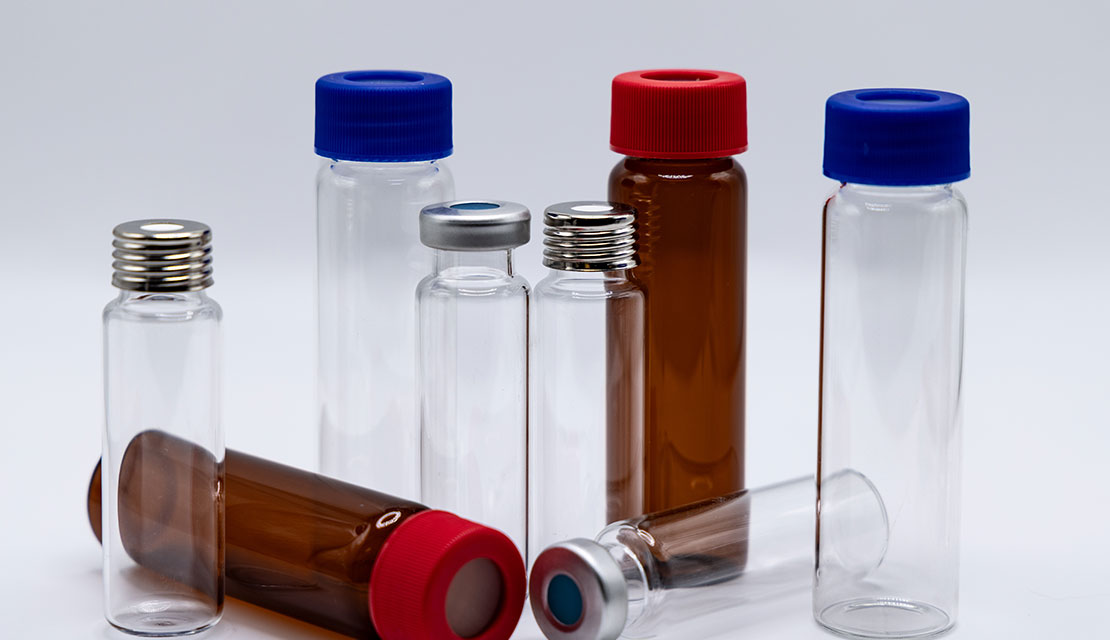 TiffVials-5-(1) Assorted clear and amber glass sample vials with red, blue, and silver caps